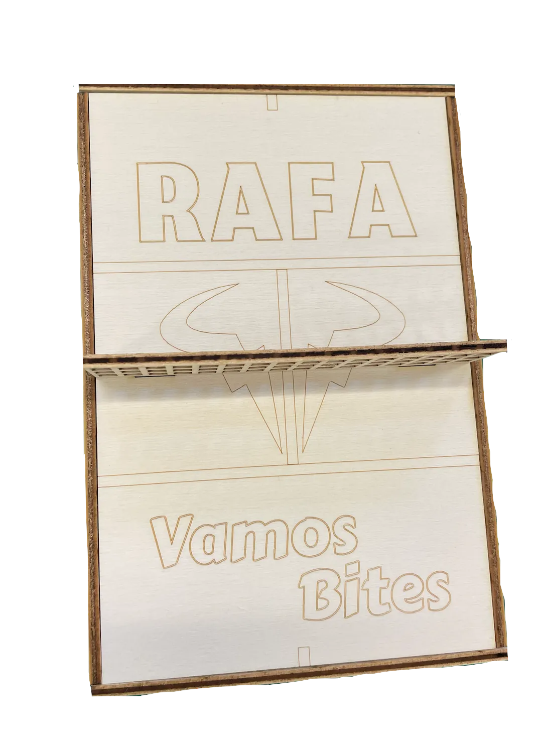 Close-up of the laser-engraved lid, showing the RAFA wordmark, bull-and-racquet logo, court lines, and Vamos Bites title on walnut.